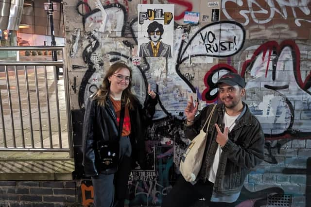 Rosie Wilson, 21, and boyfriend Ben Matthews, with her Pulp poster.