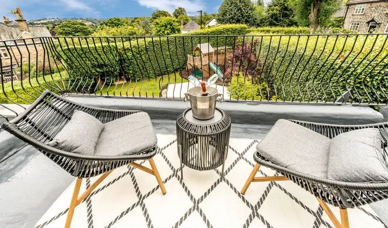 The master suite also benefits from this private balcony, which has far reaching views and looks down on the garden. (Photo courtesy of Zoopla)