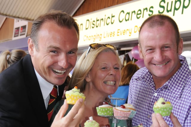 Secret Millionaire Carl Hopkins and Sunderland AFC Legend John Kay enjoy a cupcake from manager Carole Williams.
They were pictured at the opening of the new Easington District Carers Centre in Castle Dene Shopping Centre, Peterlee, in 2012.