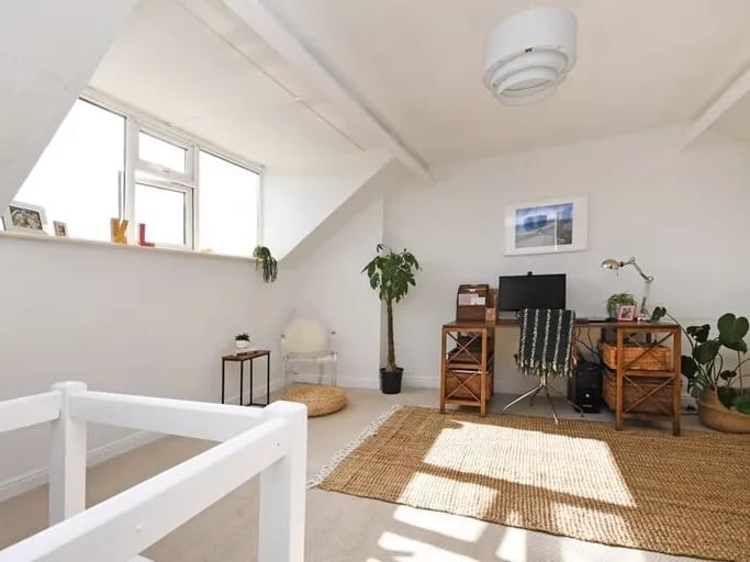 The loft bedroom is currently being used as an office. (Photo courtesy of Zoopla)