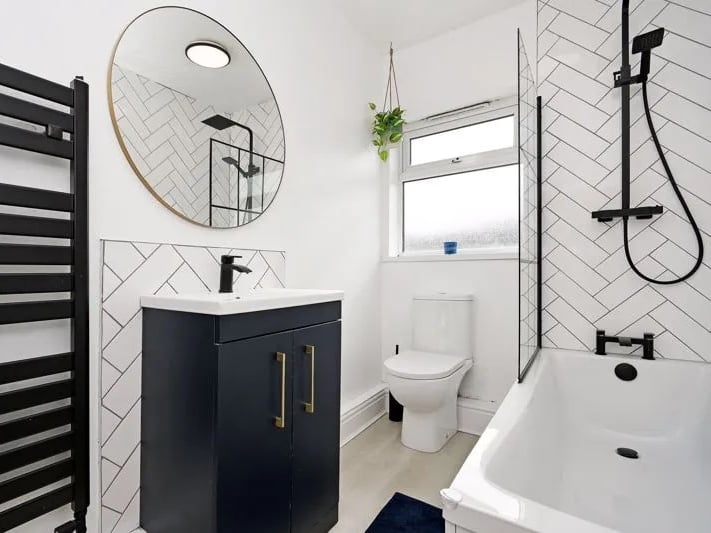 The modern bathroom comes with a shower/bath, toilet and sink. (Photo courtesy of Zoopla)