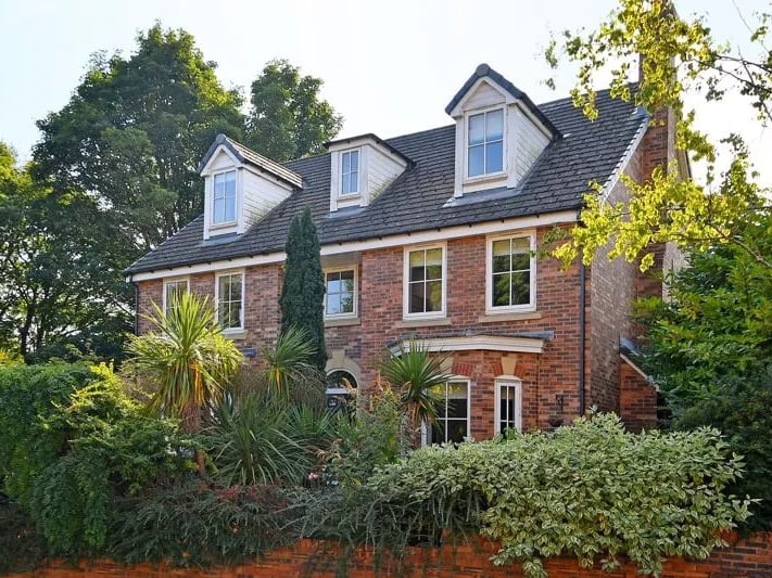 This home is tucked away behind some street-side foliage. (Photo courtesy of Zoopla)