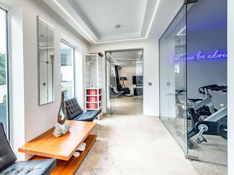The hall into the entertainment room also provides access to the home gym. (Photo courtesy of Zoopla)