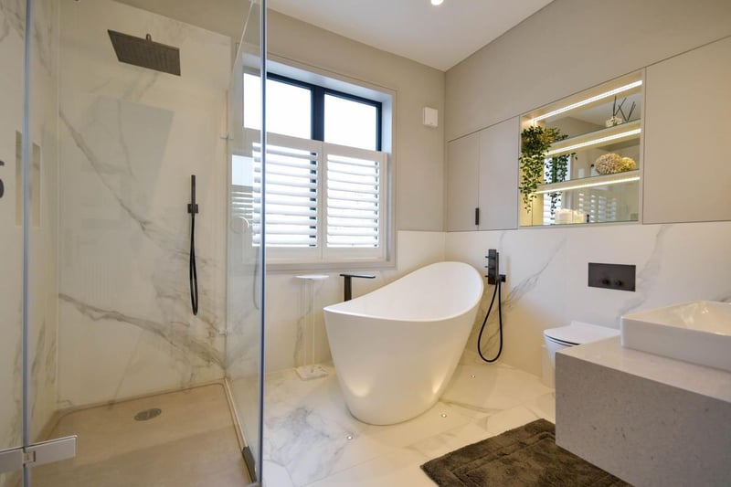The family bathroom is to the rear of the home, with a luxury free-standing bath, a walk-in shower with a stone base, a vanity wash and hand basin and a toilet.
