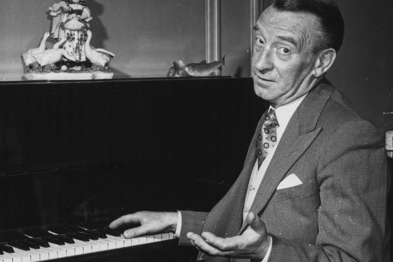 Portrait of actor and radio personality Wilfred Pickles, presenter of radio show 'Have a Go', sitting a piano in his home, circa 1950