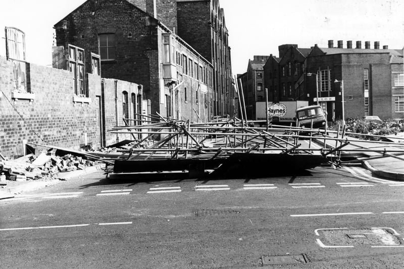Holbeck's David Street looking from Manor Road in June 1986. On the left, demolition is taking place of nos.39-41 David Street, blocking off the road in the process. On the right is a cleared area where St. Francis' R.C. Church and St. Joseph's R.C. Secondary School once stood. Behind this is a department of the Leeds Industrial Co-operative Society.