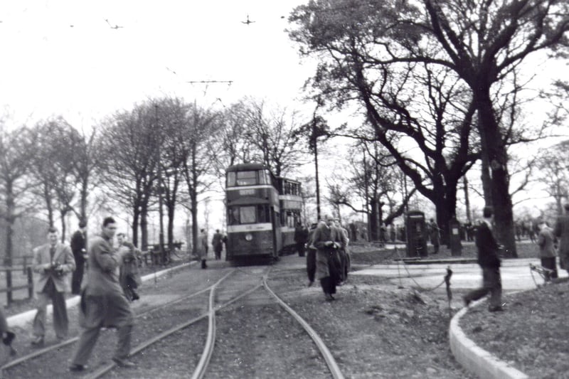 This view looks south east on Temple Newsam Road, where two trams can be seen at the terminus, near to Temple Newsam House. To the left can be seen the trees lining elm Walk, which leads up to Whitkirk.