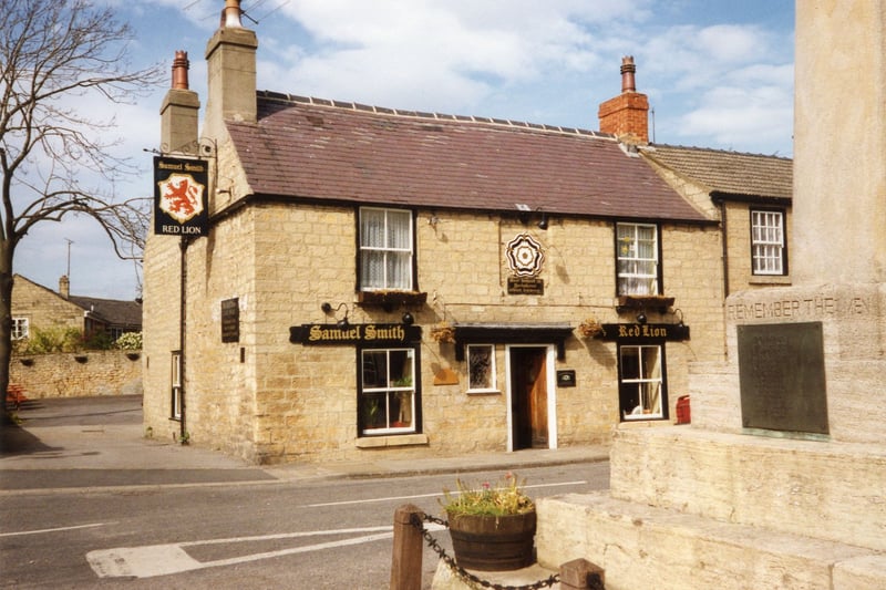  The Square at the bottom of Town Hill, showing the Red Lion, a Samuel Smith public house. In the foreground, right, is the war memorial commemorating the villagers who lost their lives in the two world wars.