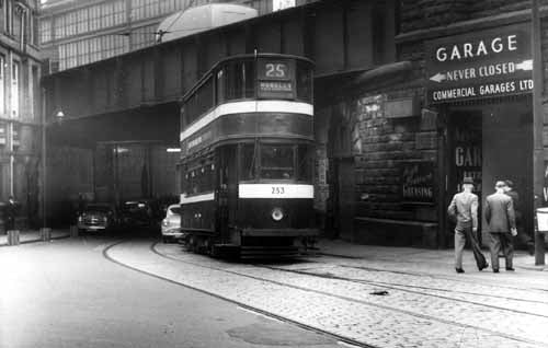 Horsfield tram no.253 coming out from under the railway bridge on Bishopgate Street, on route no.25 to Hunslet. A garage on the right belonging to Commercial Garages Ltd. proclaims to be 'never closed'. Pictured in September 1958.