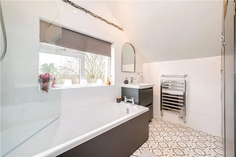 The delightfully decorated house bathroom features a shower bath.