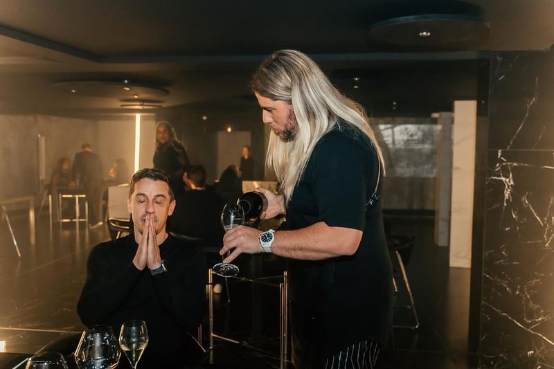 Last year, Michael O'Hare announced the closure of his Michelin-starred restaurant the Man Behind the Curtain and announced plans to open Psycho Sandbar in its place. Now open to the public, pictured is O'Hare serving Gary Neville at the launch of his new Leeds restaurant Psycho Sandbar.