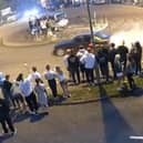 Driver does doughnuts at illegal car meet.