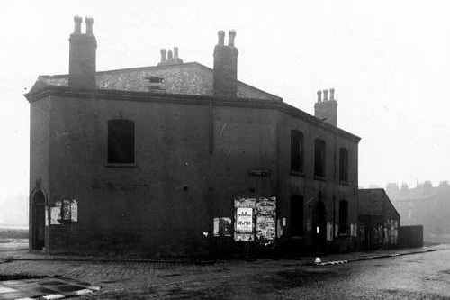 The junction of Accommodation Road and Accommodation Row, showing the derelict Pineapple Hotel at number 77. Torn posters for The Princess and The Picture House cinemas are visible. Pictured in December 1942.