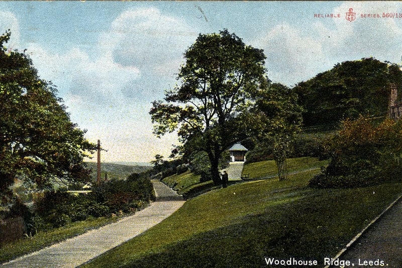 A volour-tinted postcard of Woodhouse Ridge with a postmark of August 8,  1909. The view looks south-east with the Ridge sloping down towards Meanwood on the left, where the chimney of the Leeds Corporation Refuse Destructor can be seen.