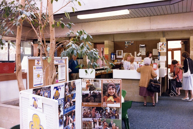 Inside Horsforth Branch Library on Town Street in June 1985. This shows the adult lending section situated in the extension to the building opened in 1975. A display celebrating the 75th anniversary of the Girl Guide Association is seen in the foreground while the counter area is in the background.