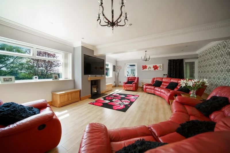 The huge living room is one of three main receptions featured in this immaculate family home.