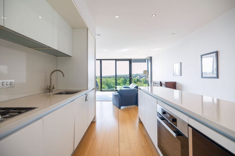 The kitchen is fitted with gloss units and integrated appliances.
