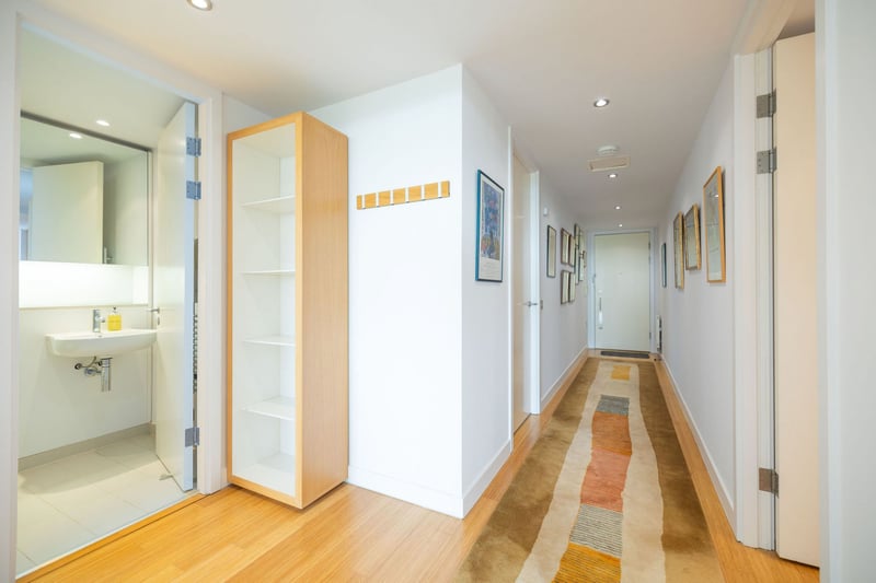 A spacious hallway links the open plan living room and kitchen with the two bedrooms.