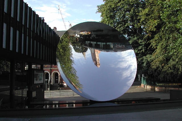 Seen outside the Nottingham Playhouse, the Sky Mirror was unveiled in April 2001 thanks to a £900,000 grant by the National Lottery. 

At 6 metres wide and weighing nearly 10 tonnes, the Sky Mirror was made in Finland through a process of cold forging. 

The mirror's shiny surface creates an ever-changing reflection of its surroundings depending on who walks past and the time of day or year.

As spring, summer, autumn and winter pass, the sculpture changes too. 