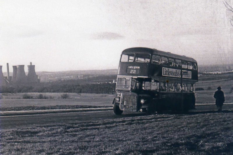 A number 22 bus travelling east along Temple Newsam Road, towards the terminus near Temple Newsam House. The view looks south-west, and the cooling towers of Skelton Grange Power station can be seen on the left.