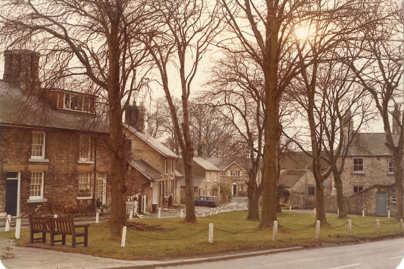 Thorp Arch village green looking towards Paddock House in the distance. The war memorial step is in the bottom left corner of the photograph. The cottages on the left have distinguishing 6 chimney clusters. The house on the right is the Manor House and the road in the foreground, known as The Village, continues south to become Bridge Foot and over Thorp Arch Bridge to Boston Spa.
