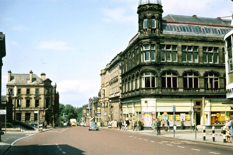 Queen Street looking north from opposite the Town Hall buildings. The photograph was probably taken in the late 1960s. Lloyds Bank, the Nat West Bank and the Midland Bank buildings have all been sandblasted, but Barclays has not yet moved into the 1899 Co-op building which is still soot blackened. The bus stops are still simple barriers without any shelter as yet.