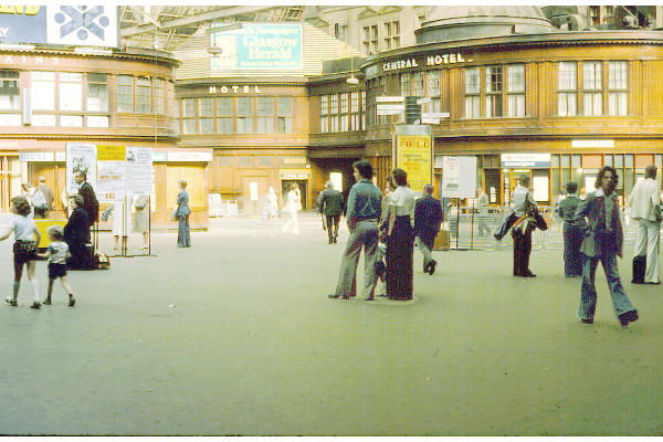 Passengers pictured waiting on their trains inside Glasgow Central station in July 1975. 
