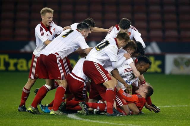 Sheffield United Academy goalkeeper Aaron Ramsdale is mobbed by his team mates after an heroic penalty shoot out display against Bradford City in the FA Youth Cup