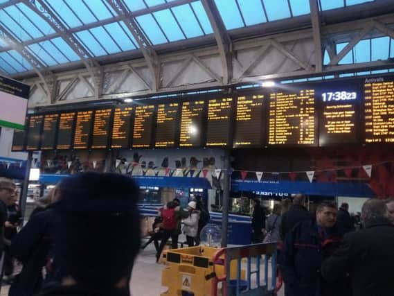 Commuters check the boards at Sheffield Station to see if their trains are on time