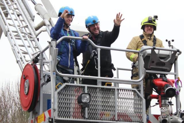 Joe gets a demonstration of firefighting equipment.