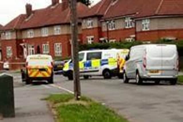 Police on Kyle Crescent in Southey Green, Sheffield, where a woman was slashed in the neck