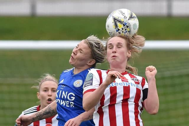 Goalscorer Bex Rayner challenges for a header against Leicester