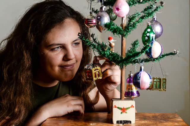 Kaye Ashton's 12 year old grandaughter Tallulah Plastow with the 98-year-old Christmas tree. Picture: Dan Rowlands/SWNS.com