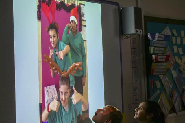 Eco-friendly Christmas cards and gifts launched by Eco-Warriors at Athelstan Primary School. Josh and Maryam view the results in the classroom. Pictures: Scott Merrylees