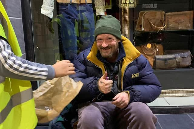 Young volunteers from the As-Salaam Foodbank distribute hot meals in Sheffield city centre