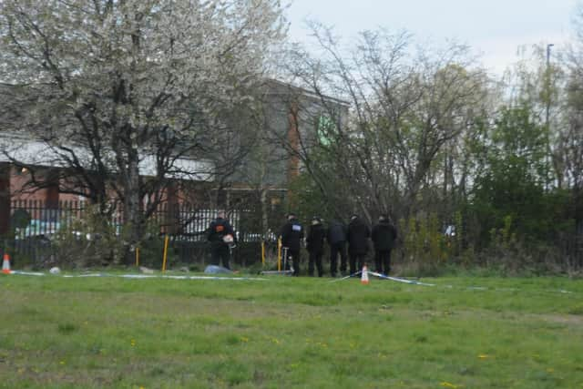 Officers carrying out searches for evidence.