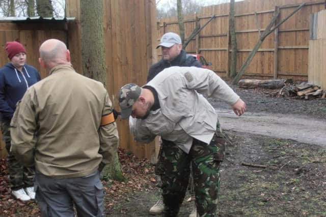 James Swallow-Gaunt restraining a man during a self-defence demonstration