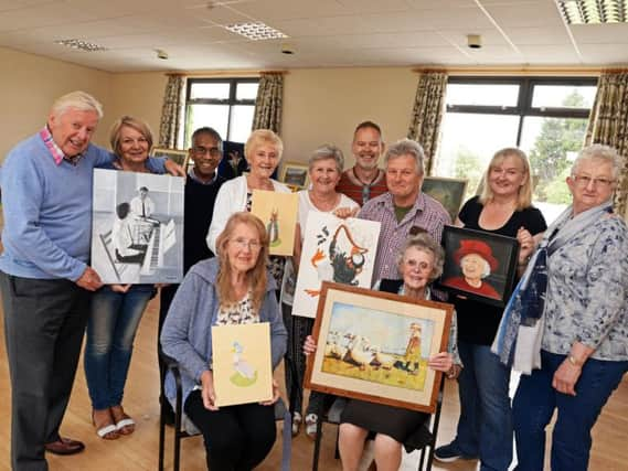 Mark Holiday, group tutor, pictured with members of Hayfield Art group, during their annual exhibition at Bawtry New Hall. Picture: Marie Caley NDFP Hayfield Art Group MC 1