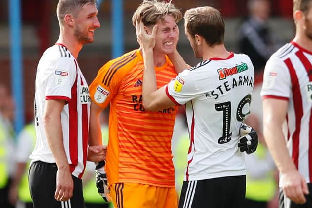 Dean Henderson takes in the moment with Richard Stearman