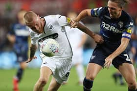 Swansea City's Oli McBurnie holds off Leeds United's Luke Ayling during the Sky Bet Championship match at the Liberty Stadium, Swansea.  David Davies/PA Wire.