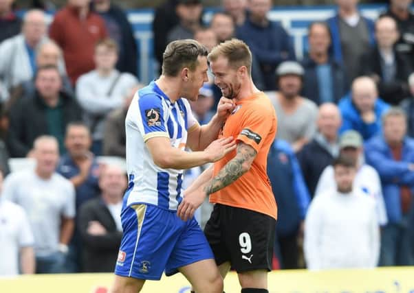 Chesterfield's Lee Shaw is challenged by Hartlepool's Carl Magnay. Pic by Howard Roe/AHPIX.com.