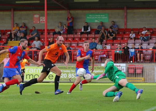 Picture by Gareth Williams/AHPIX.com; Football; Vanarama National League; Dagenham & Redbridge v Chesterfield FC; 15/09/2018 KO 15:00; Chigwell Construction Stadium; copyright picture; Howard Roe/AHPIX.com; Dagenham keeper Elliot Justham gets fingers to a cross to deny Tom Denton a tap-in