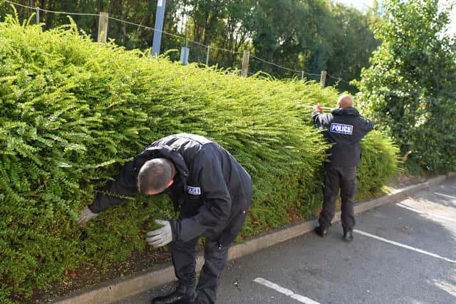 Police Search teams at work in land around the edge of Centertainment