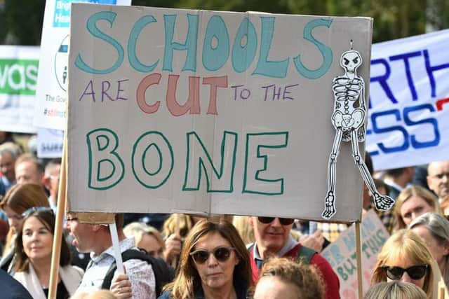 Headteachers from across England and Wales hold signs in Parliament Square, London, as they prepare to march on Downing Street to demand extra cash for schools. Picture: Kirsty O'Connor/PA Wire