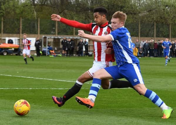 Sheffield Wednesday U23's Fraser Preston battles with Sheffield United U23's Jake Bennett.