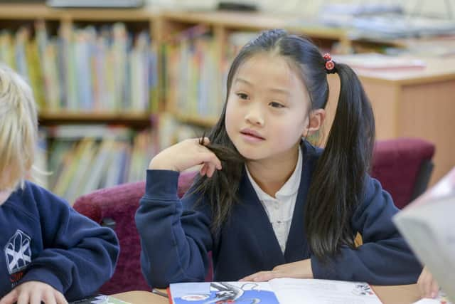 Year three pupils enjoy reading in the library