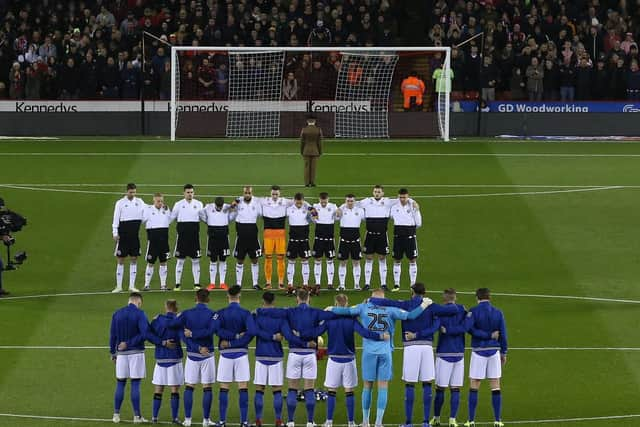 Players from both Sheffield United and Sheffield Wednesday line up for a minutes silence during the Sky Bet Championship match at Bramall Lane Stadium, Sheffield