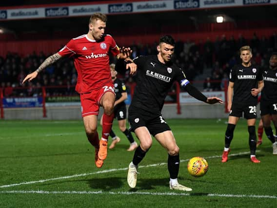 Barnsley's Kieffer Moore takes on Accrington's Nick Anderton.