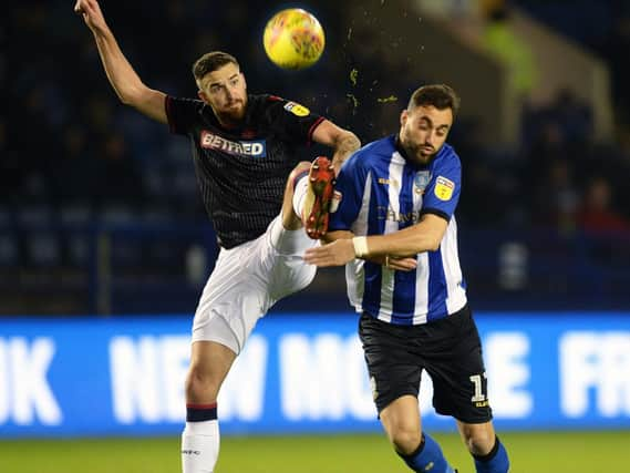 Boltons ex Owl Mark Beevers with Atdhe Nuhiu......Pic Steve Ells