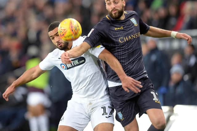 Owls Atdhe Nuhiu holds off Citys Cameron Carter-Vickers. Pic Steve Ellis.